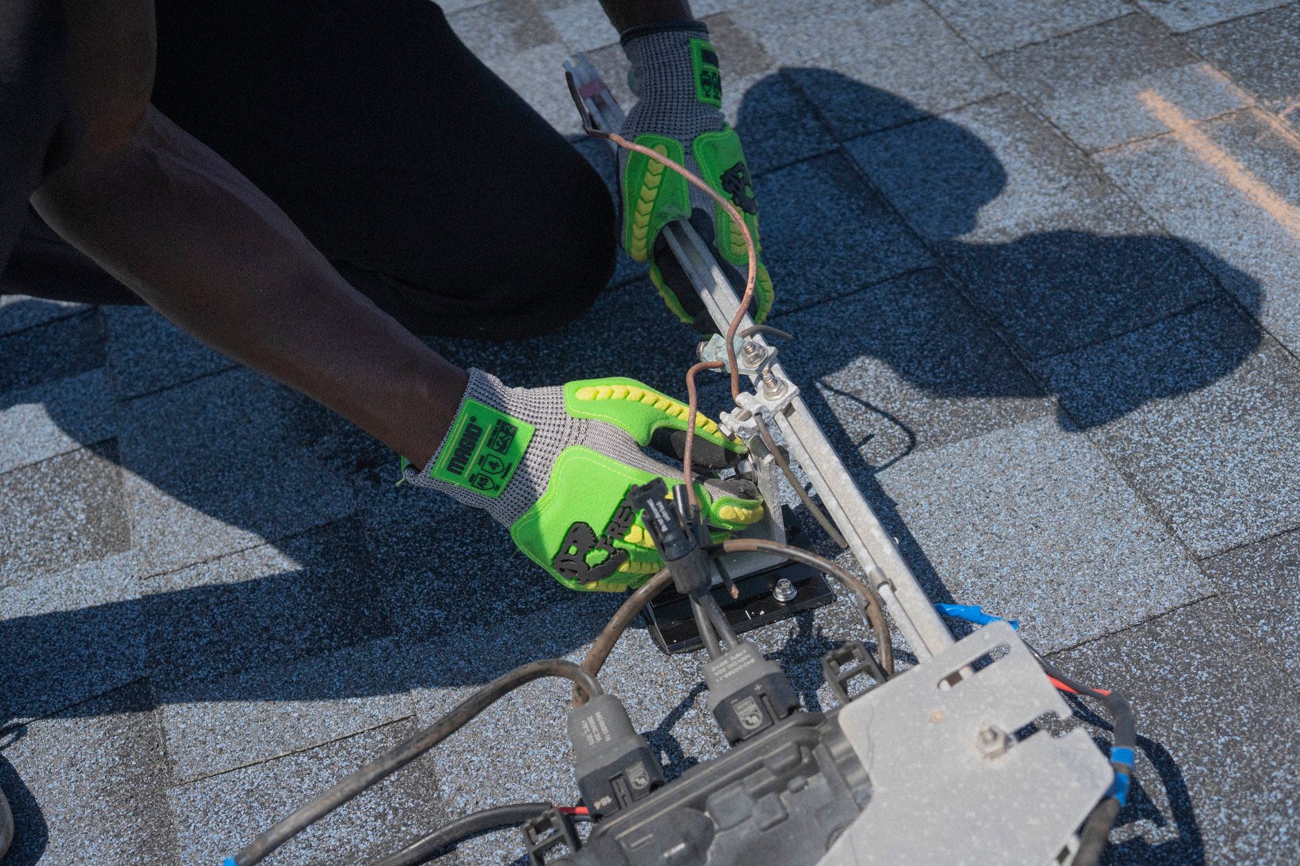 Technician installing a flexible solar panel on an RV roof