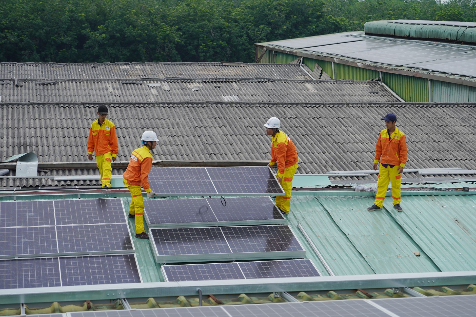 an installer holding a solar panel on a roof during a site survey